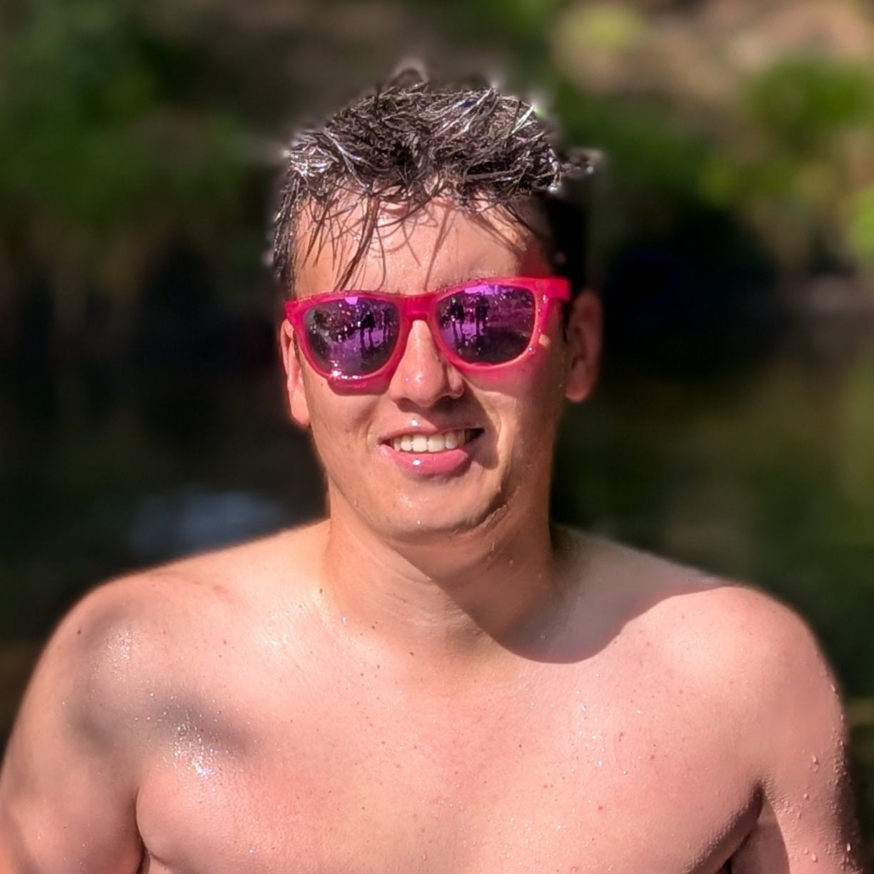Man wearing bright pink sunglasses