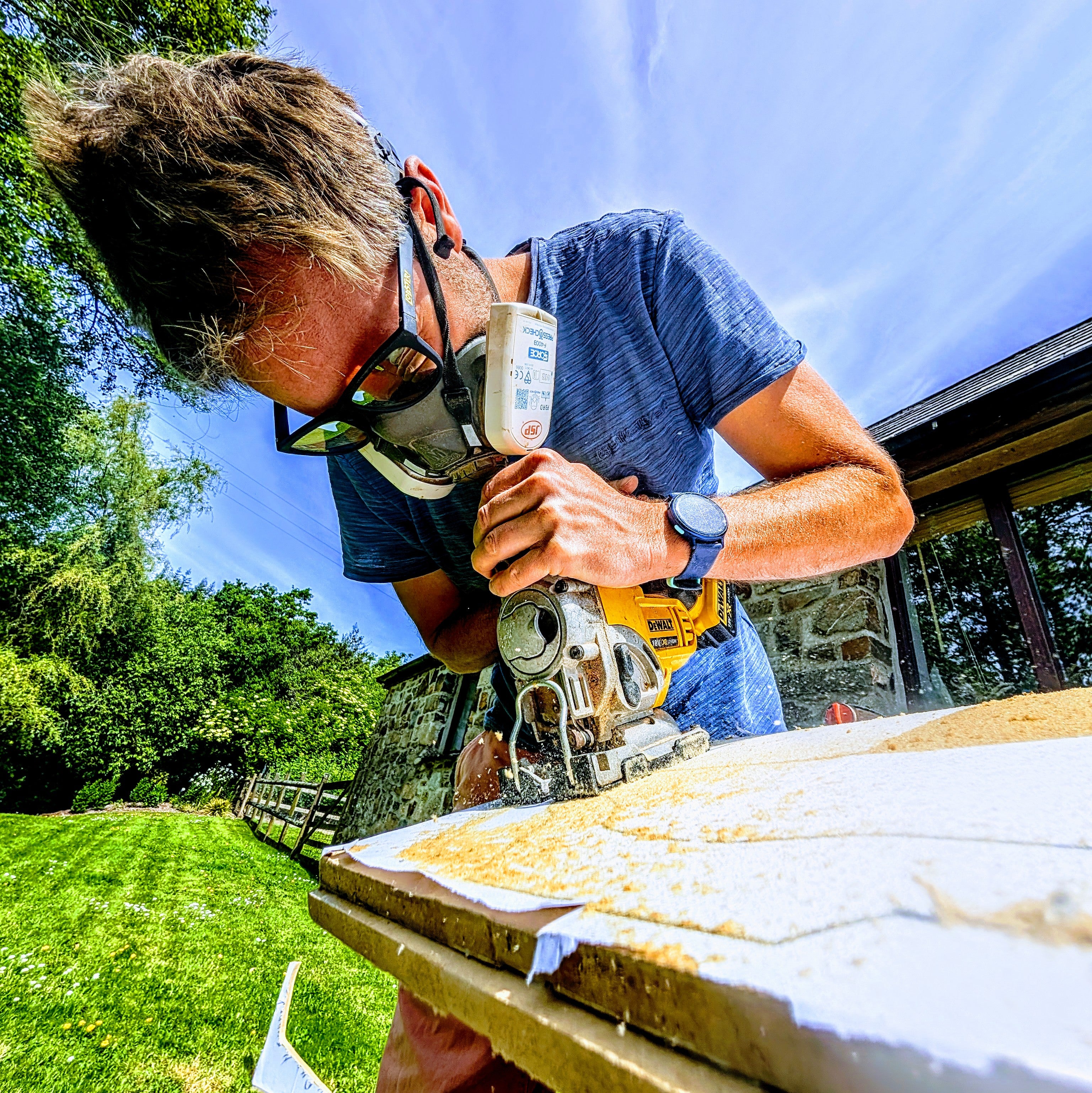 Man cutting wood wearing sunglasses